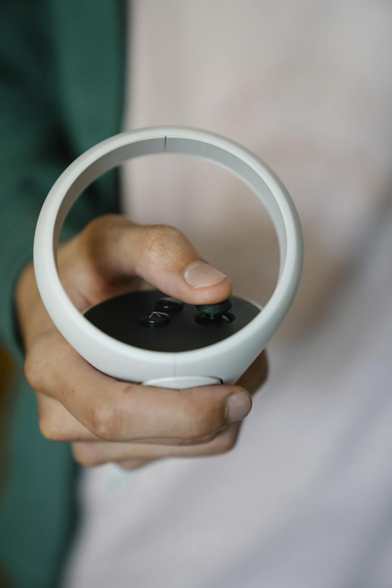 Crop anonymous gamer using remote controller for headset for virtual reality while playing video game